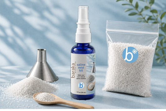 Baraka saline mist kit with bottle, 2 ounces sea salt, and funnel on a light blue background